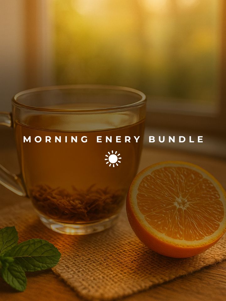 Glass mug of golden herbal tea with orange slices in warm morning sunlight.