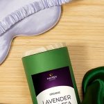 A tin of Naveen Lavender Sleep Tea placed beside a silk sleep mask on a wooden surface, representing rest, serenity, and nighttime relaxation.