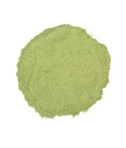 Bright green alfalfa leaf powder on a white background, representing natural detoxification and nutrient-rich superfood benefits.