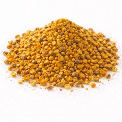Pile of bee pollen granules on white textured background