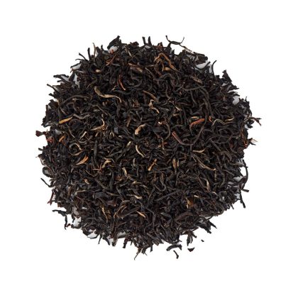 Pile of loose black tea leaves on white textured background