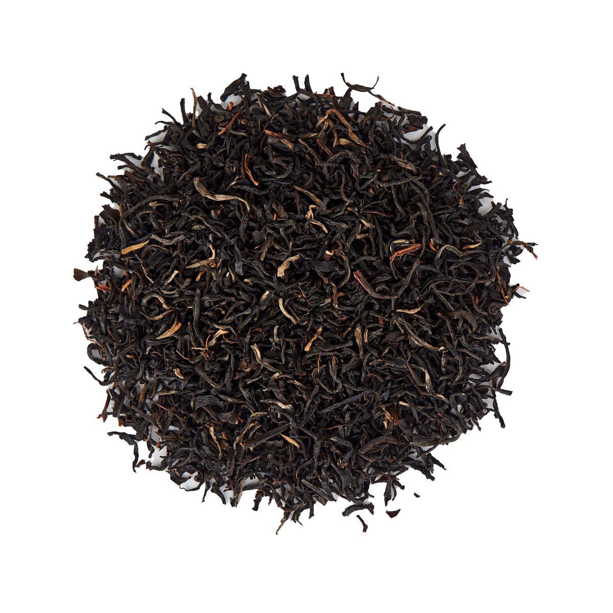 Pile of loose black tea leaves on white textured background