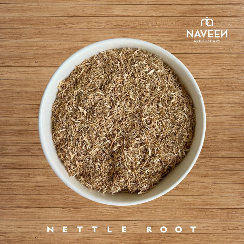 A bowl of dried nettle root pieces on a wooden surface with the Naveen Apothecary logo.