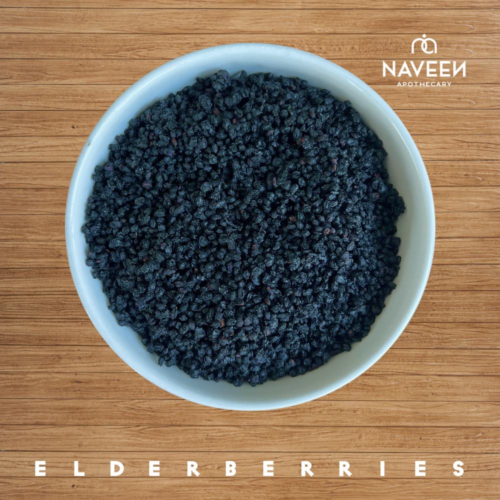 A bowl of dried elderberries on a wooden surface with the Naveen Apothecary logo.