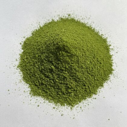 Pile of dried moringa leaf powder from Naveen Herbs on white background
