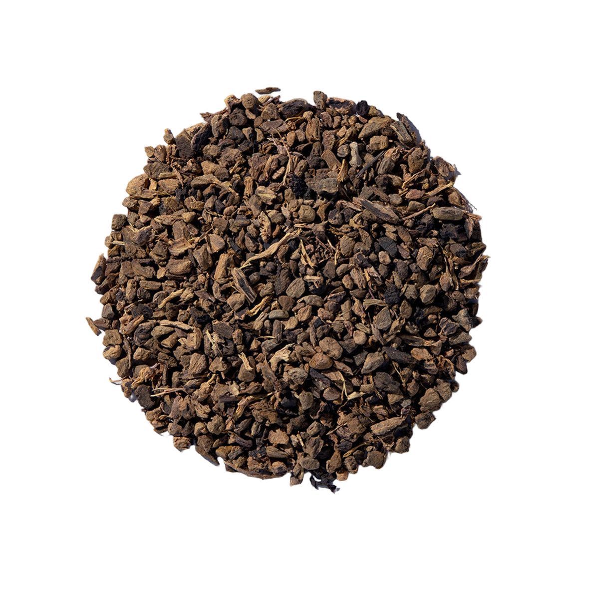 Pile of dried yellow dock root from Naveen Herbs on a white background