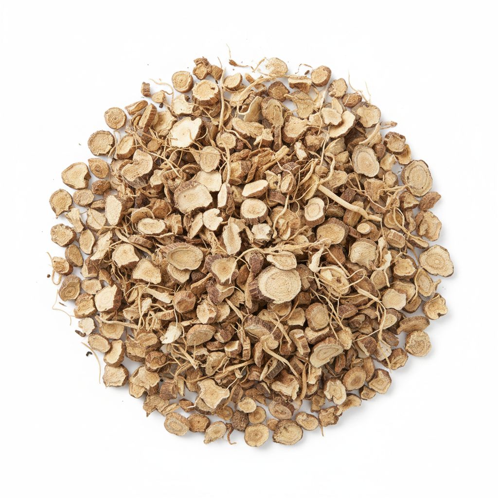 Dried sliced angelica root pieces piled on a white background.