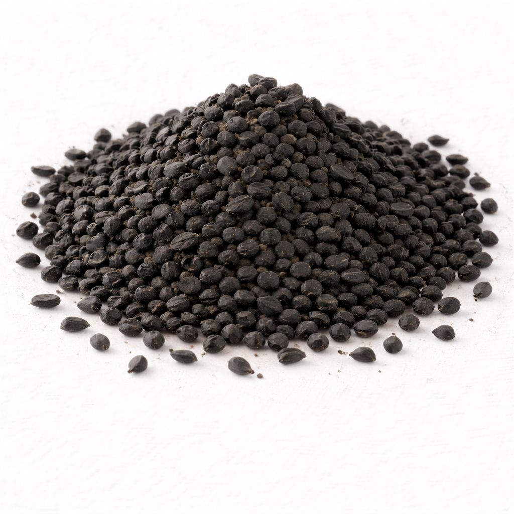 Pile of black nigella sativa seeds on white textured background