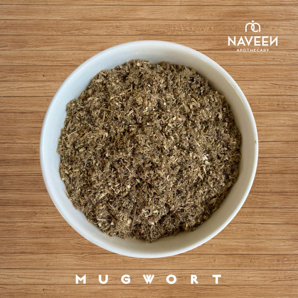 A bowl of dried mugwort herb on a wooden surface with the Naveen Apothecary logo.