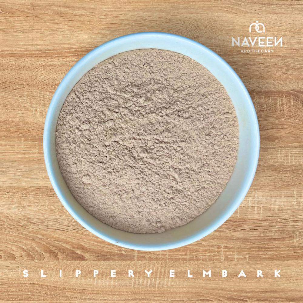 A bowl of powdered slippery elm bark on a wooden surface with the Naveen Apothecary logo.