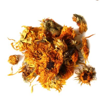 Pile of dried calendula flowers from Naveen Herbs on a white background