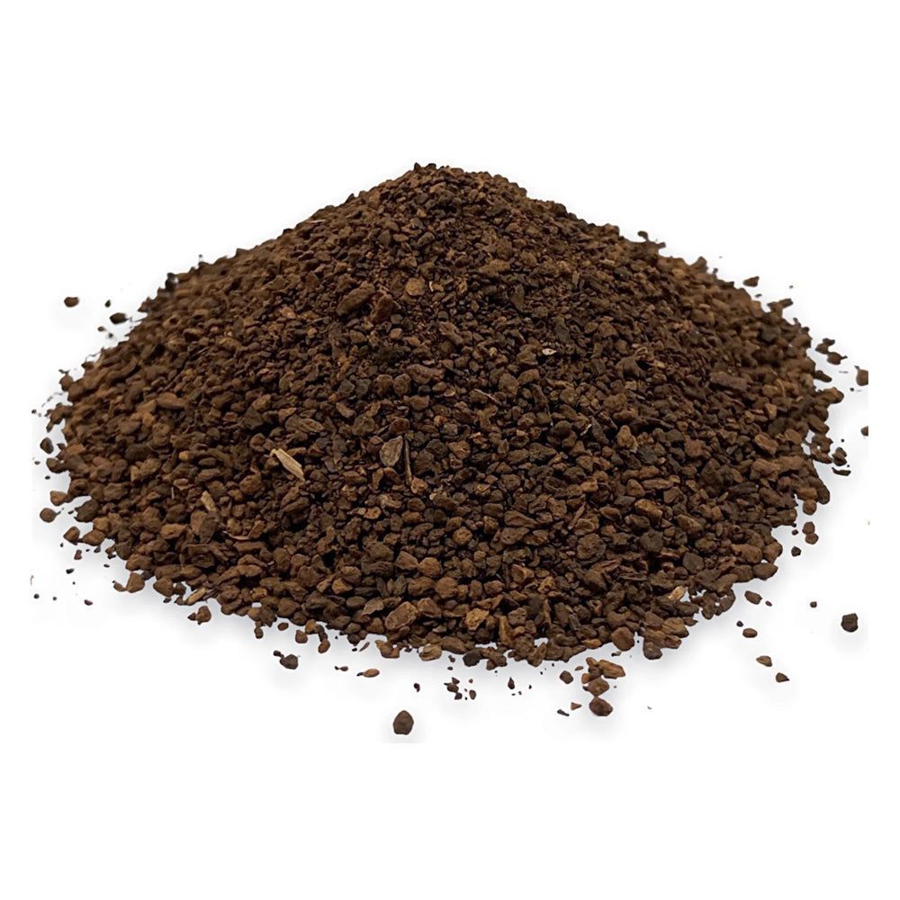 Pile of roasted chicory root from Naveen Herbs on a white background