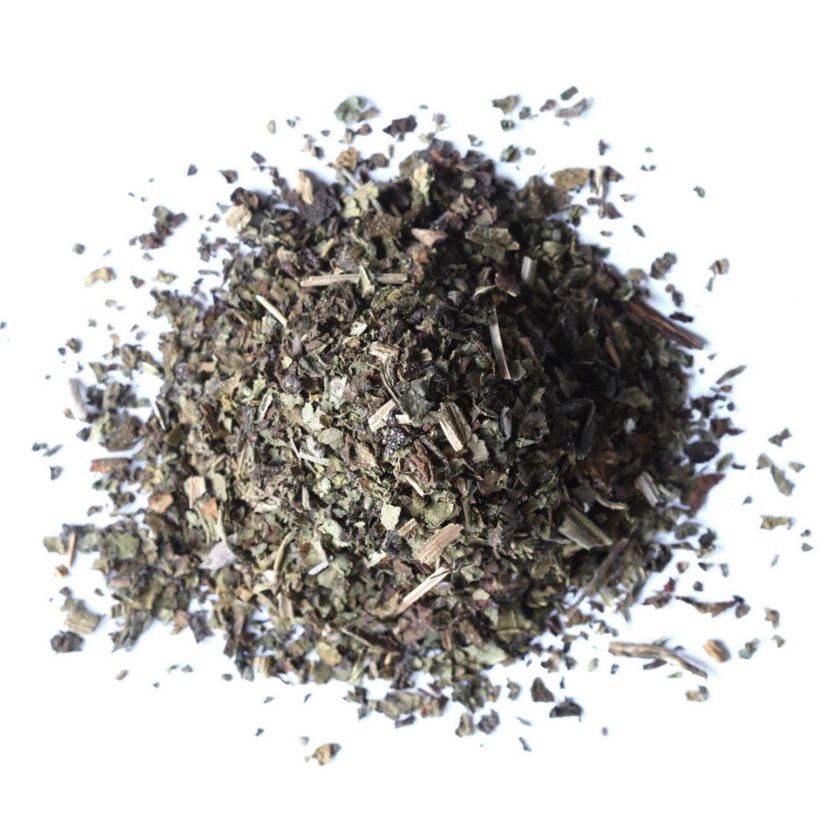 Pile of dried comfrey leaf from Naveen Herbs on a white background