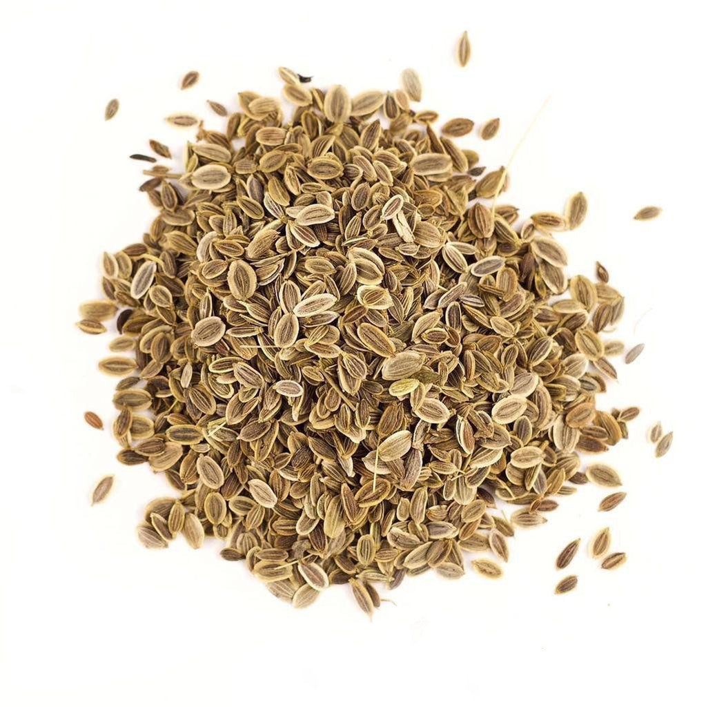 Pile of dill seeds from Naveen Herbs on a white background