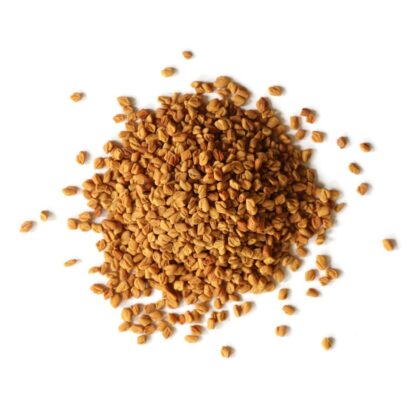 Pile of fenugreek seeds on a white background