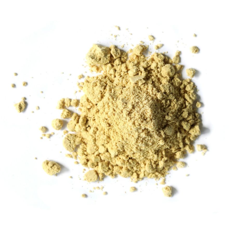 Pile of ginger root powder on a white background