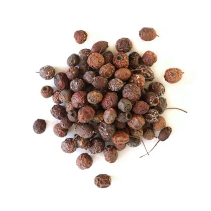Pile of dried hawthorn berries on a white background