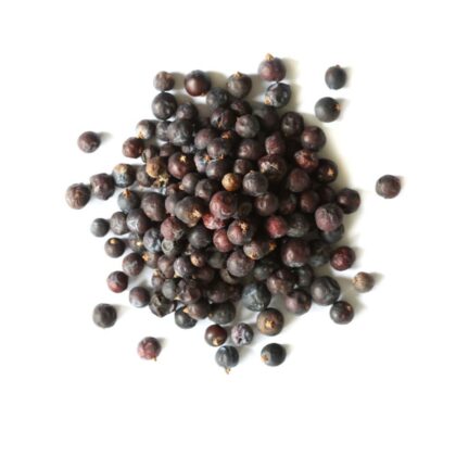 Pile of dried juniper berries on a white background