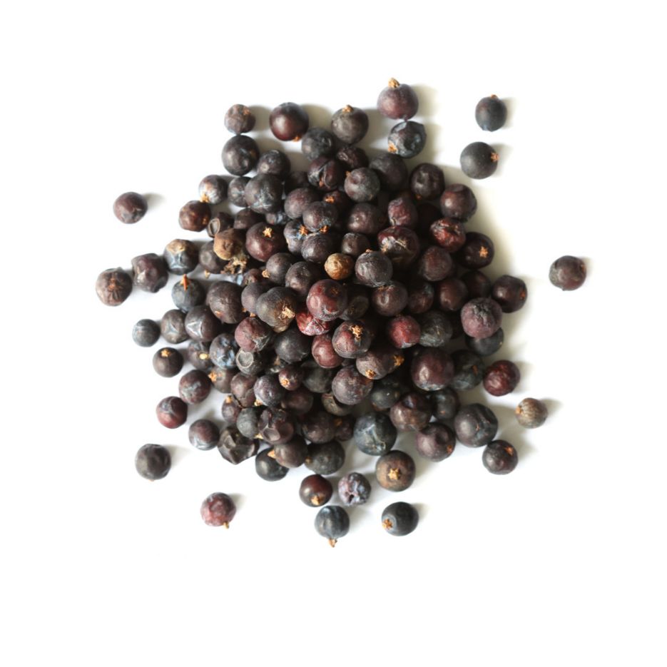 Pile of dried juniper berries on a white background