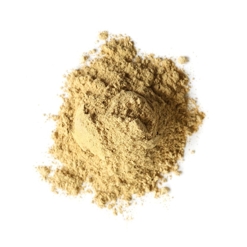 Pile of licorice root powder on a white background