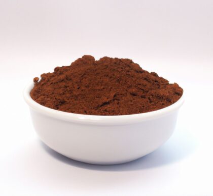 Pile of cocoa powder from Naveen Herbs on a white background