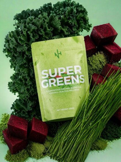 Super greens powder pouch with kale leaves, wheatgrass, and beetroot cubes showing organic detox superfood blend
